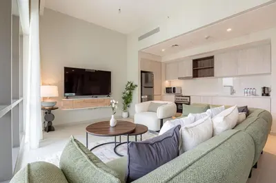 a living room with a couch and a table at Two Bedroom Apartment Down Town in Dubai