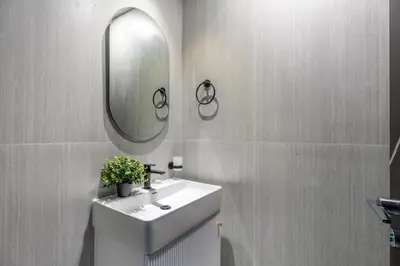 a bathroom with a sink and a mirror at GuestReady - 1 BHK | 5min to Butterfly Garden in Dubai