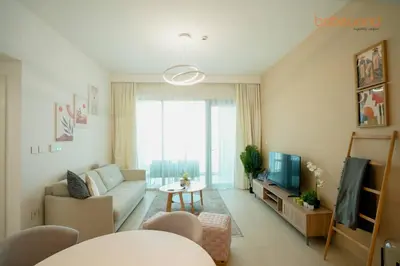 a living room with a couch and a tv at Bnbeyond Skyline Luxury in Dubai