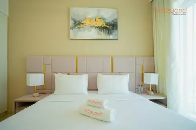 a bedroom with a large white bed with two lamps at Bnbeyond Skyline Luxury in Dubai