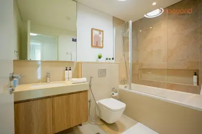 a bathroom with a toilet and a sink and a shower at Bnbeyond Skyline Luxury in Dubai