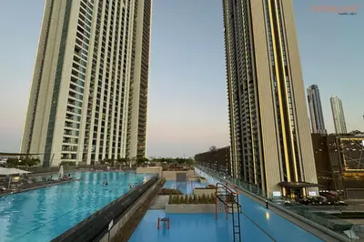 a large swimming pool in a city with tall buildings at Bnbeyond Skyline Luxury in Dubai