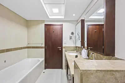 a bathroom with a tub and a sink and a bath tub at Breathtaking Burj Khalifa & Fountain Views! in Dubai