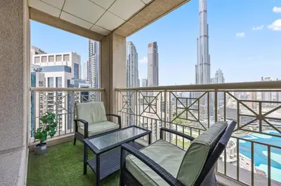a balcony with two chairs and a table at Breathtaking Burj Khalifa & Fountain Views! in Dubai