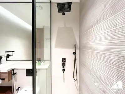 a bathroom with a shower with a glass door at Exclusive 1BR, Modern Comfort & Prime Location in Dubai