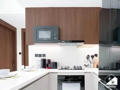 a kitchen with a tv on top of a stove at Exclusive 1BR, Modern Comfort & Prime Location in Dubai