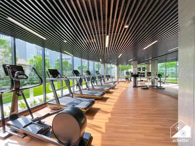 a gym with a row of treadmills and machines at Exclusive 1BR, Modern Comfort & Prime Location in Dubai