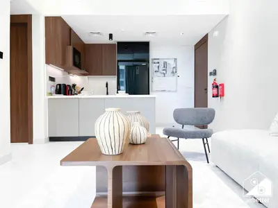 two vases sitting on a coffee table in a living room at Exclusive 1BR, Modern Comfort & Prime Location in Dubai