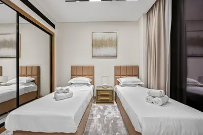 a bedroom with two beds with towels on them at Trillionaire Residences By Binghatti - Classy 2BR in Dubai