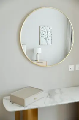 a mirror on a white wall above a white table at Star of Dubai Marina 2 Br 5 Guests in Dubai