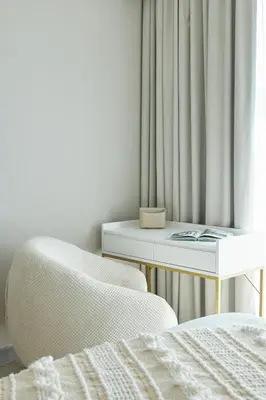 a bedroom with a chair and a table and a window at Star of Dubai Marina 2 Br 5 Guests in Dubai