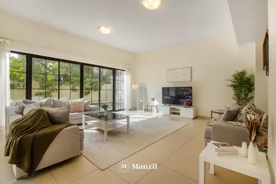 a living room with a couch and a table at 4BR Villa in Prime Location with Private Garden in Dubai