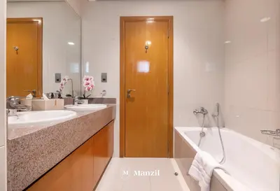 a bathroom with two sinks and a bath tub at 4BR Villa in Prime Location with Private Garden in Dubai