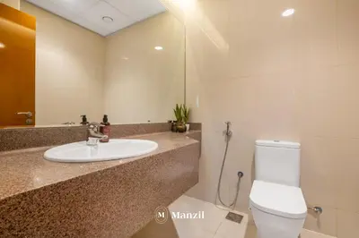 a bathroom with a sink and a toilet at 4BR Villa in Prime Location with Private Garden in Dubai