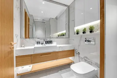 a bathroom with a sink and a toilet and a mirror at Elegant Studio Retreat in the Heart of Dubai in Dubai