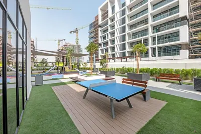 a patio with a table and benches in a building at Elegant Studio Retreat in the Heart of Dubai in Dubai