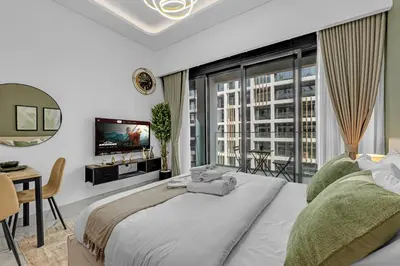 a bedroom with a large bed and a large window at Elegant Studio Retreat in the Heart of Dubai in Dubai