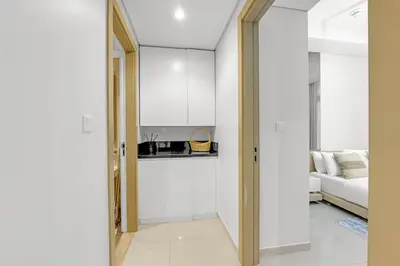 a hallway with a door leading to a living room at Elegant 1 Bedroom Retreat in Business Bay in Dubai