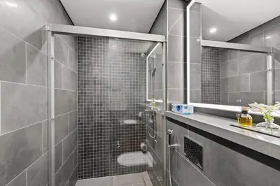 a bathroom with a shower with a glass door at Elegant 1BR with Bedroom Balcony - Sobha Crest C in Dubai