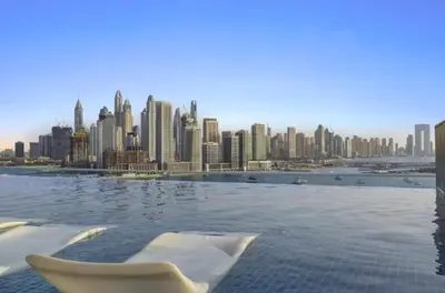 a view of a city skyline with a swimming pool at Wonderful Stay at 7 Palm - Rooftop Infinity Pool - Direct Beach Access - Brand New Luxury Apartments in Dubai