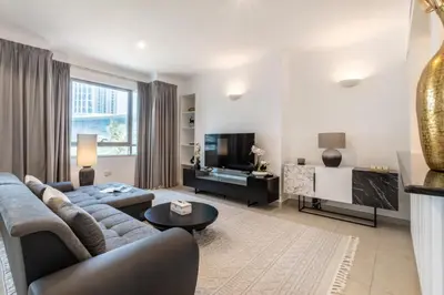 a living room with a couch and a tv at GlobalStay The Residences Tower 1 Apartments Downtown Dubai in Dubai