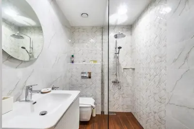 a white bathroom with a sink and a shower at GlobalStay The Residences Tower 1 Apartments Downtown Dubai in Dubai