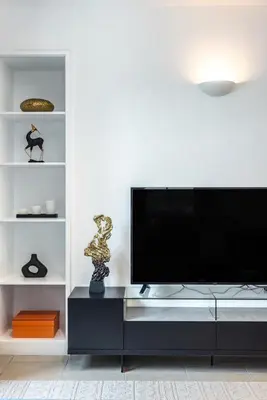 a living room with a flat screen tv on a entertainment center at GlobalStay The Residences Tower 1 Apartments Downtown Dubai in Dubai