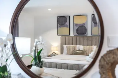 a bedroom with a bed and a mirror at GlobalStay The Residences Tower 1 Apartments Downtown Dubai in Dubai