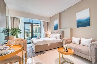 a living room with a bed and a couch at Upgraded LUX Infinity Pool with Beach Access in Dubai
