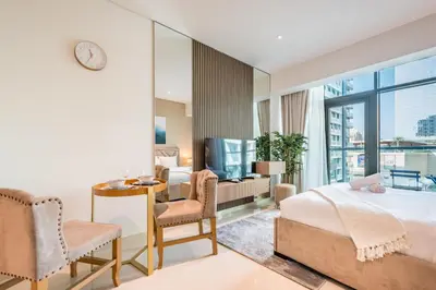 a hotel room with a bed and a desk and chair at Upgraded LUX Infinity Pool with Beach Access in Dubai