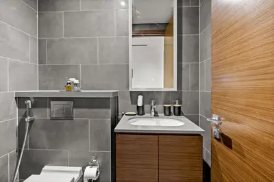 a bathroom with a sink and a toilet at Bright, Breezy and Central 1BR with Extra Room in Dubai