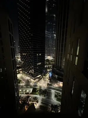 a view of a city at night with buildings at Boema Apartments - Terrace with Stunning Burj View in Dubai
