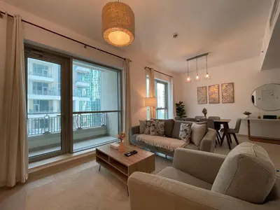 a living room with a couch and a table at 2BR apartment in the Heart of Downtown Dubai with Burj Khalifa View by Norbu Holiday Homes in Dubai