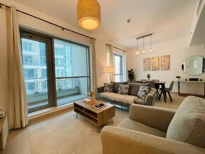 a living room with a couch and a table at 2BR apartment in the Heart of Downtown Dubai with Burj Khalifa View by Norbu Holiday Homes in Dubai