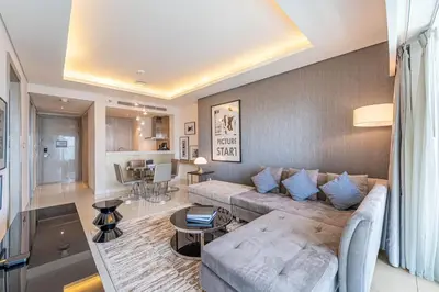 a living room with a couch and a table at Stylish Stay - 1 Bedroom - High Floor in Dubai