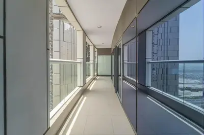 an empty corridor in a building with windows at Stylish Stay - 1 Bedroom - High Floor in Dubai