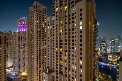 a view of tall buildings in a city at night at GuestReady - 2BR | JBR Beach Stay | Canal View in Dubai