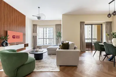 a living room with chairs and a couch and a table at GuestReady - 2BR | JBR Beach Stay | Canal View in Dubai