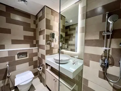 a bathroom with a toilet and a sink and a shower at LUX Infinity Pool with GYM, Private Beach Studio in Dubai