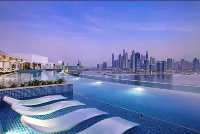 a hotel swimming pool with a view of the city at LUX Infinity Pool, Gym, Beach, Parking Studio in Dubai