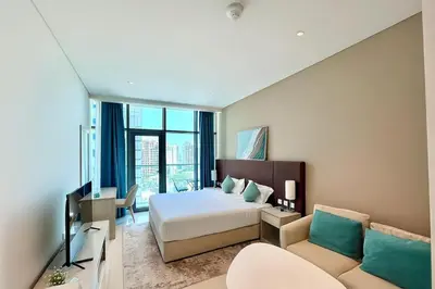 a hotel room with a bed and a couch at LUX Infinity Pool, Gym, Beach, Parking Studio in Dubai