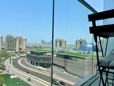 a view of a building with a highway and buildings at LUX Infinity Pool, Gym, Beach, Parking Studio in Dubai
