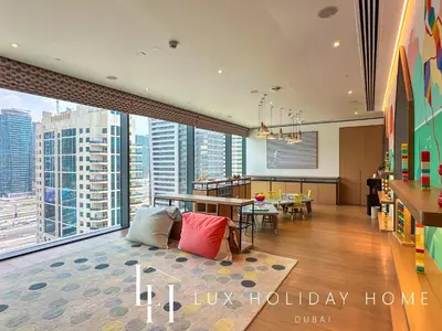 a living room with a view of a building at LUX The Vida Marina Residence in Dubai