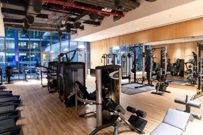 a gym with several treadmills and exercise machines at LUX Infinity Pool, Private Beach, GYM, Parking in Dubai