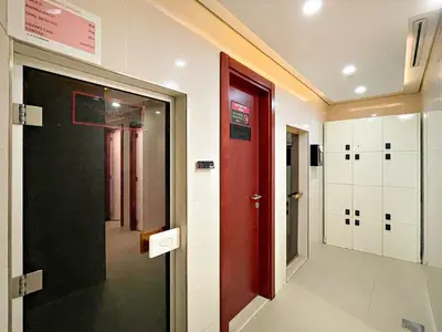 a hallway with a red door and white lockers at FIRST CLASS Studio Cozy Elegance in Dubai