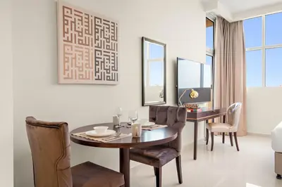 a dining room with a table and chairs at FIRST CLASS Studio Cozy Elegance in Dubai