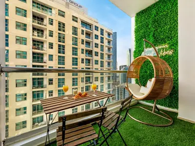 a balcony with a table and a chair and a building at Urban Dubai Marina Stay, Near Yacht Area & Beach Sleep 8 Pax in Dubai