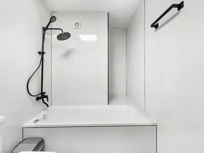 a shower in a white bathroom with a lamp at Urban Dubai Marina Stay, Near Yacht Area & Beach Sleep 8 Pax in Dubai