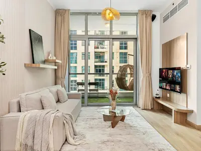 a living room with a couch and a large window at Urban Dubai Marina Stay, Near Yacht Area & Beach Sleep 8 Pax in Dubai