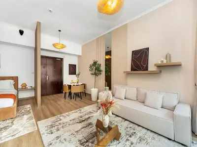 a living room with a white couch and a table at Urban Dubai Marina Stay, Near Yacht Area & Beach Sleep 8 Pax in Dubai